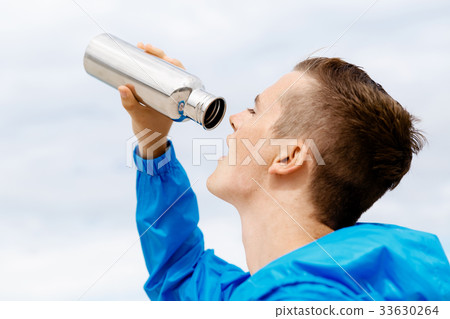 Man drinking from a sports bottle 33630264