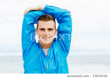 Man training on beach outside 33630348