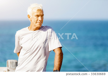 Man standing on beach in sports wear 33630669