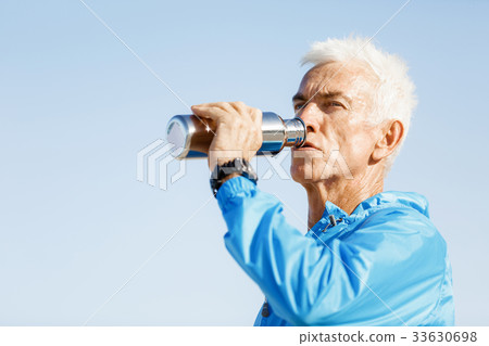 Man drinking from a sports bottle Man drinking from a sports bottle 33630698