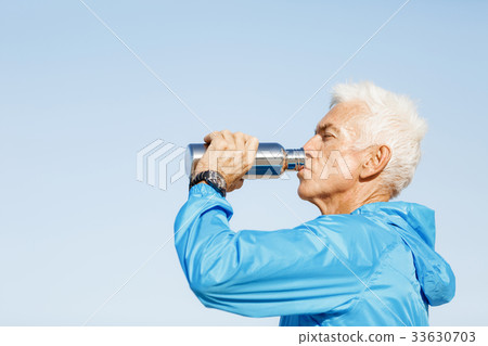 Man drinking from a sports bottle Man drinking from a sports bottle 33630703