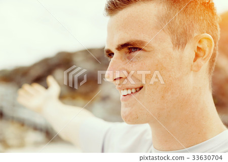 Young man in sport wear with outstretched arms 33630704