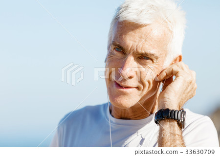 Sports and music. man getting ready for jogging Sports and music. man getting ready for jogging 33630709