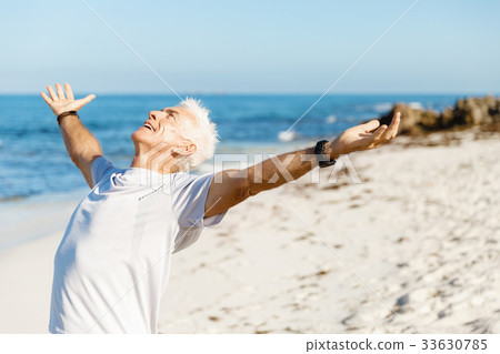 Handsome man in sport wear with outstretched arms 33630785