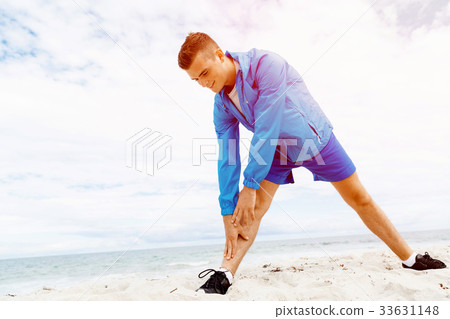 Man training on beach outside 33631148