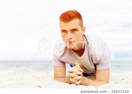 Man training on beach outside 33631310