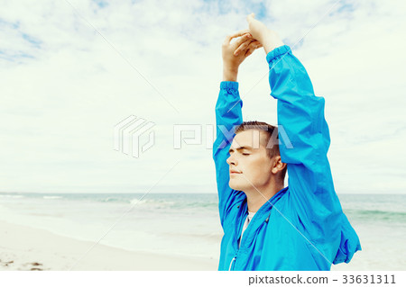Man training on beach outside Man training on beach outside 33631311