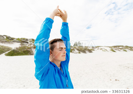 Man training on beach outside 33631326