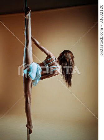 Young woman pole dancing 33632120
