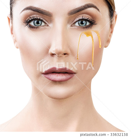 Beautiful woman with honey on face. 33632138