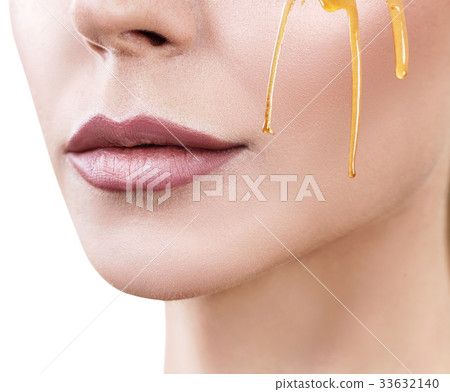 Beautiful woman with honey on face. Beautiful woman with honey on face. 33632140