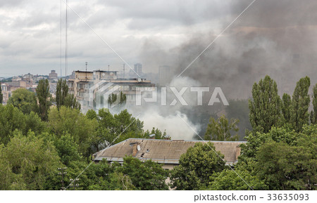 smoke from a fire in the city. 33635093