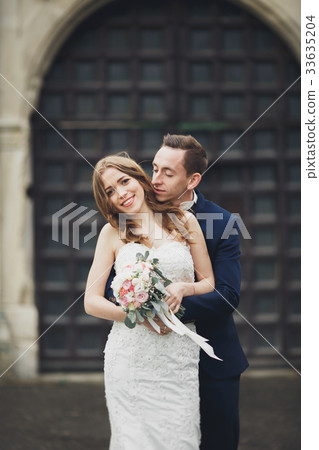Happy wedding couple hugging and smiling each 33635204