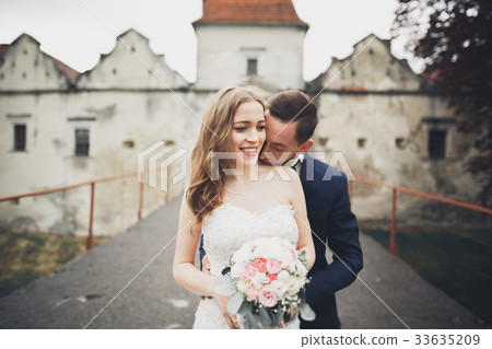 Happy wedding couple hugging and smiling each 33635209