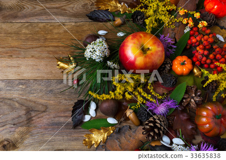 Fall decoration with flowers and apple on wood 33635838