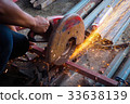 Worker use grinder to cut the tube 33638139