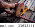 Worker use grinder to cut the tube. 33638141