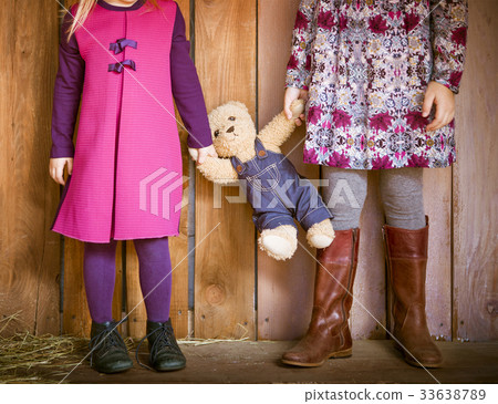 Two little sisters with toy bear 33638789