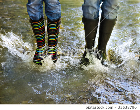 Happy couple wearing colorful rain boots Happy couple wearing colorful rain boots 33638790