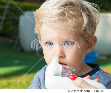 Mom cleaning baby boy nose outdoor Mom cleaning baby boy nose outdoor 33640102