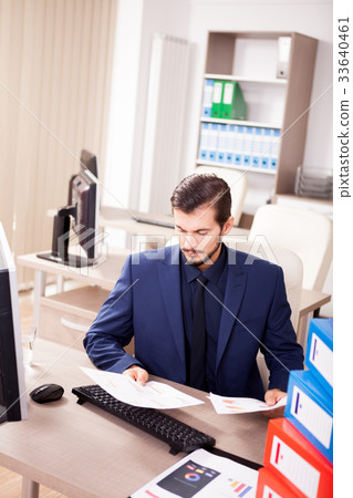 Young businessman depressed from the workload Young businessman depressed from the workload 33640461
