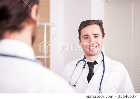 Two doctors in hospital recovery room talking Two doctors in hospital recovery room talking 33640537