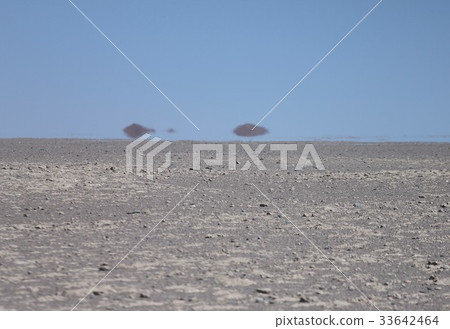 A distant mountain swaying in the heat blaze seen from the desert area near Calama in northern South America Chile 33642464