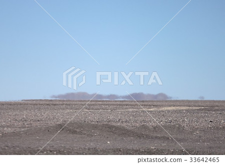 A distant mountain swaying in the heat blaze seen from the desert area near Calama in northern South America Chile 33642465