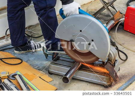 worker cutting metal with compound mitre saw 33643501