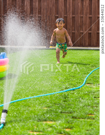 Garden wood deck lawn boy water play 33644012