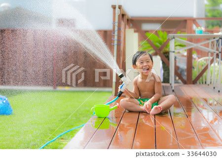 Garden wood deck lawn boy water play 33644030