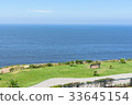 empty bench facing towards the ocean coast  33645154