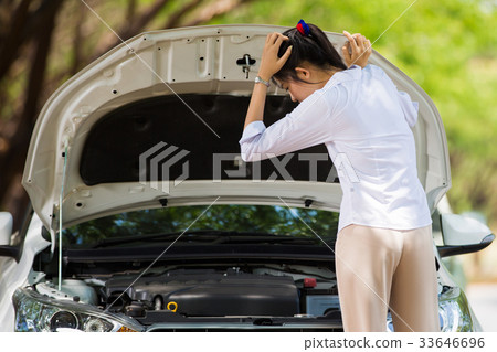 Woman beside her broken car She opened the hood  33646696