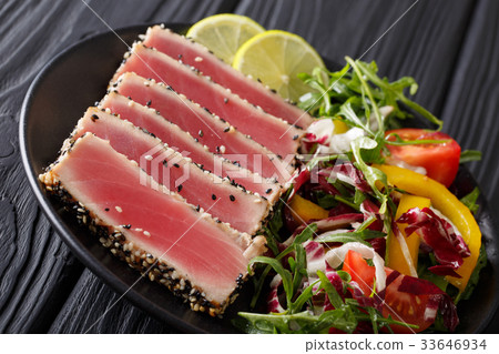 Delicious Tuna Steak in sesame, lime and salad Delicious Tuna Steak in sesame, lime and salad 33646934