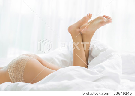 Buttock of a woman lying on her bed relaxed. 33649240