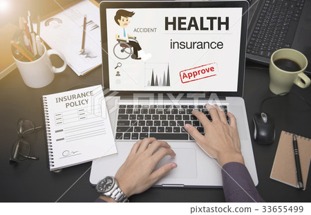 hand using computer with health insurance  33655499