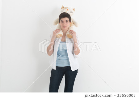 Young smiling woman in white shirt and jeans with 33656005
