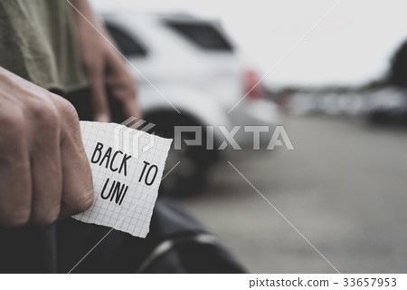 man with a note with the text back to university 33657953