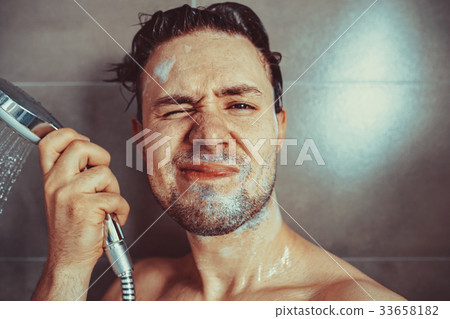 Young man washing head Young man washing head 33658182