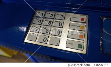 Blue color ATM machine and white button keypad. Blue color ATM machine and white button keypad. 33658986