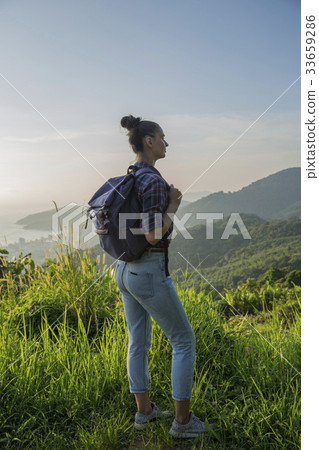 Hipster young girl with backpack enjoying sunset Hipster young girl with backpack enjoying sunset 33659286