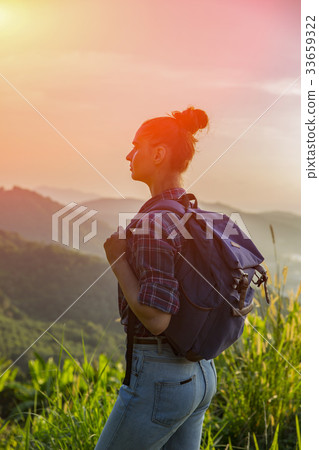 Hipster young girl with backpack enjoying sunset Hipster young girl with backpack enjoying sunset 33659322