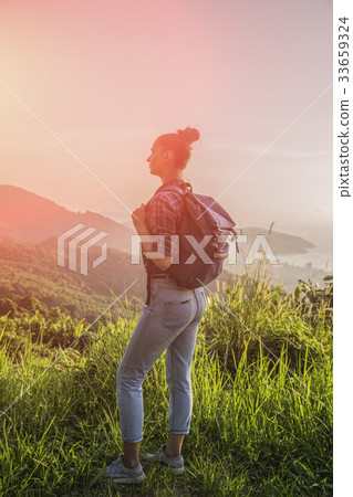 Hipster young girl with backpack enjoying sunset Hipster young girl with backpack enjoying sunset 33659324