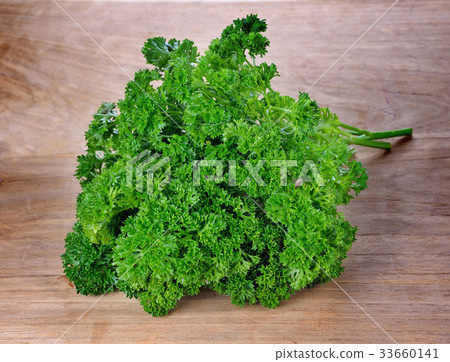 fresh parsley on wooden background. fresh parsley on wooden background. 33660141