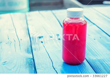 Plastic bottle with red fruit drink in restaurant Plastic bottle with red fruit drink in restaurant 33661227