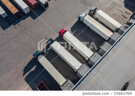Trucks unloading in logostics hub Trucks unloading in logostics hub 33663769