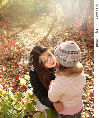 Two sisters in autumn forest 33664419