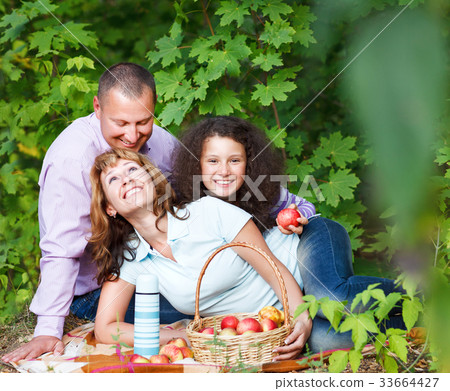 Happy young family with daughter on picnic 33664427