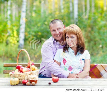 Happy smiling couple in the autumn forest. Sunset 33664428