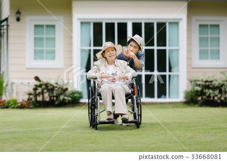 Elderly woman relax in backyard with daughter 33668081